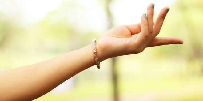 A woman's hand reaching out to the sky.