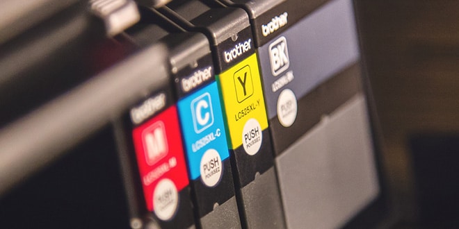 A close up of a printer with ink cartridges.