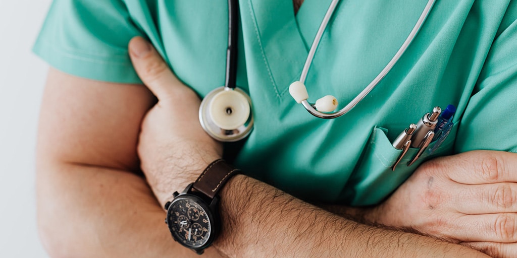 A nurse with a stethoscope and a watch.