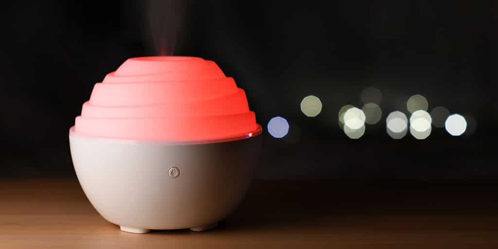 An ultrasonic diffuser sitting on top of a table.