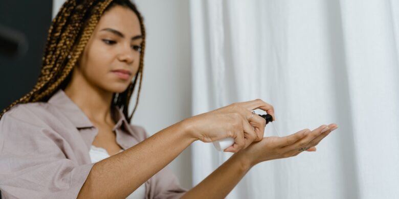 A young black woman is holding a phone in her hand.