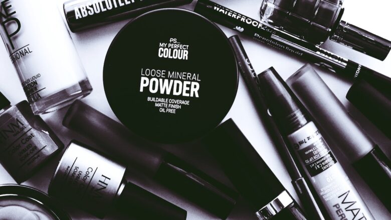 Black and white makeup products on a white surface.