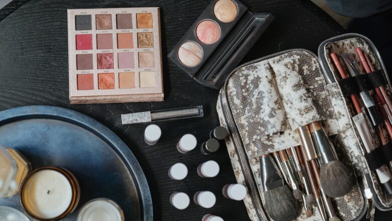 Makeup brushes and cosmetics on a table.