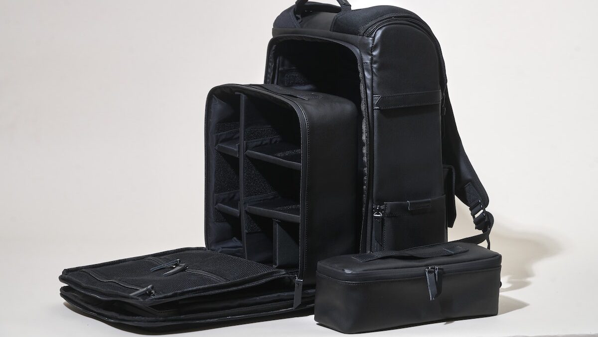 A black camera backpack bag/case with several compartments.